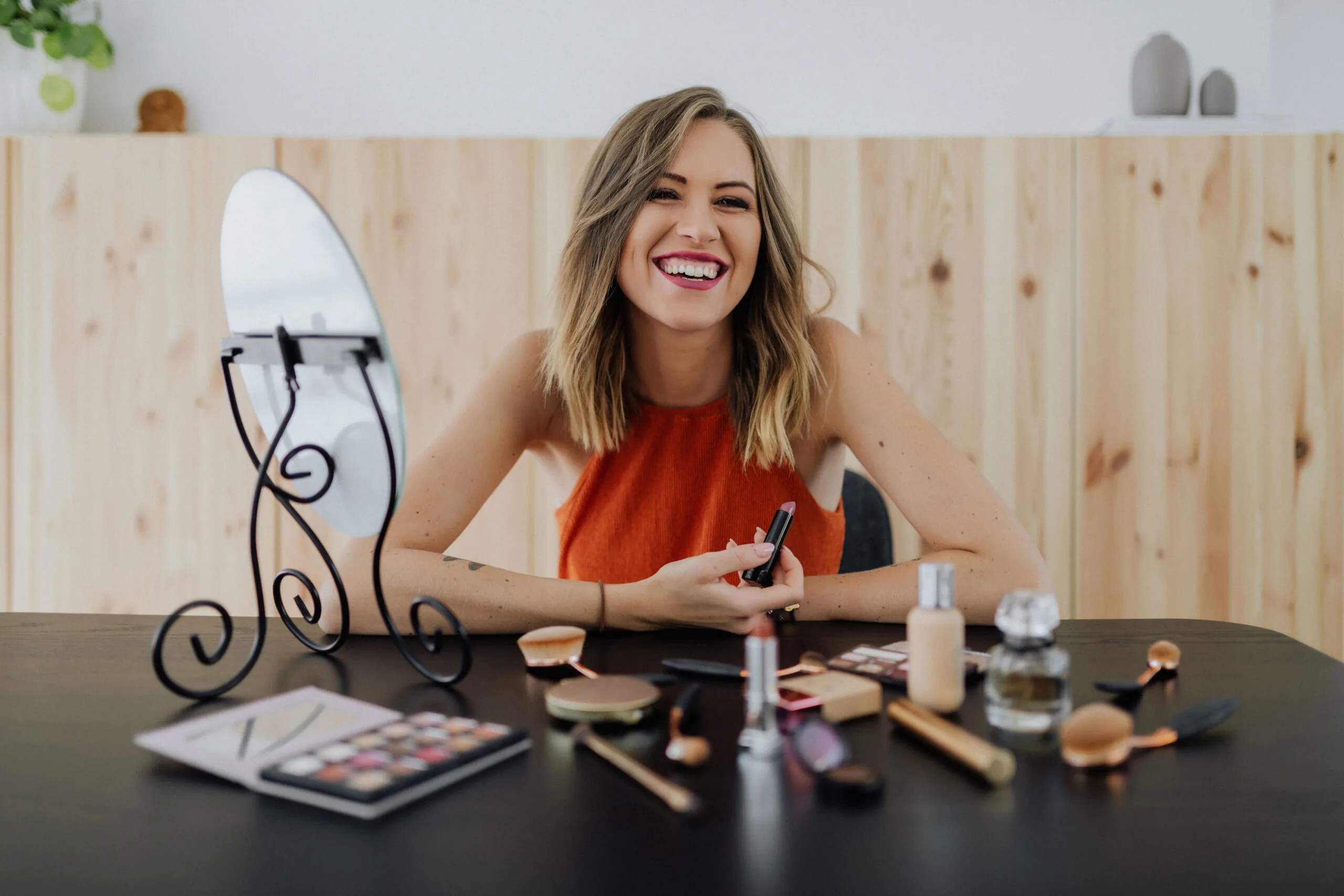 kaboompics_young-woman-sitting-and-doing-makeup-in-front-of-mirror-13750